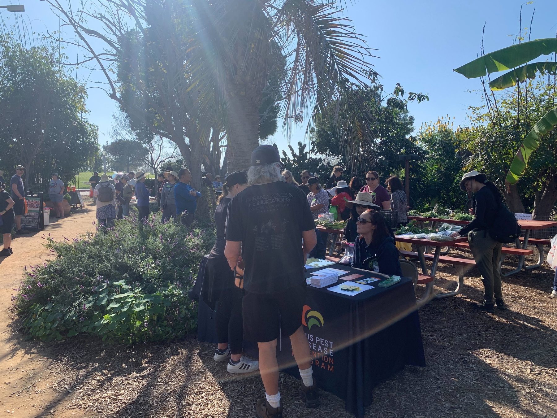 Community members gathered at an educational booth during an event at the Farm + Food Lab