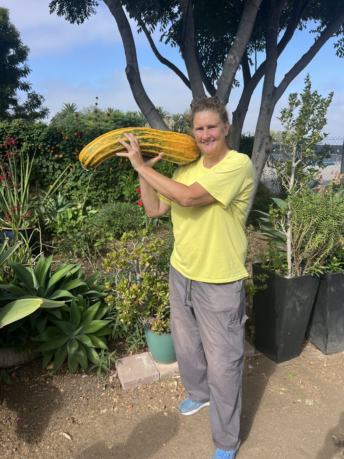 Person holding large squash at Farm + Food Lab