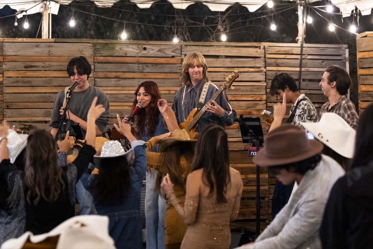Band performing for guests under string lights at Harvest Moon