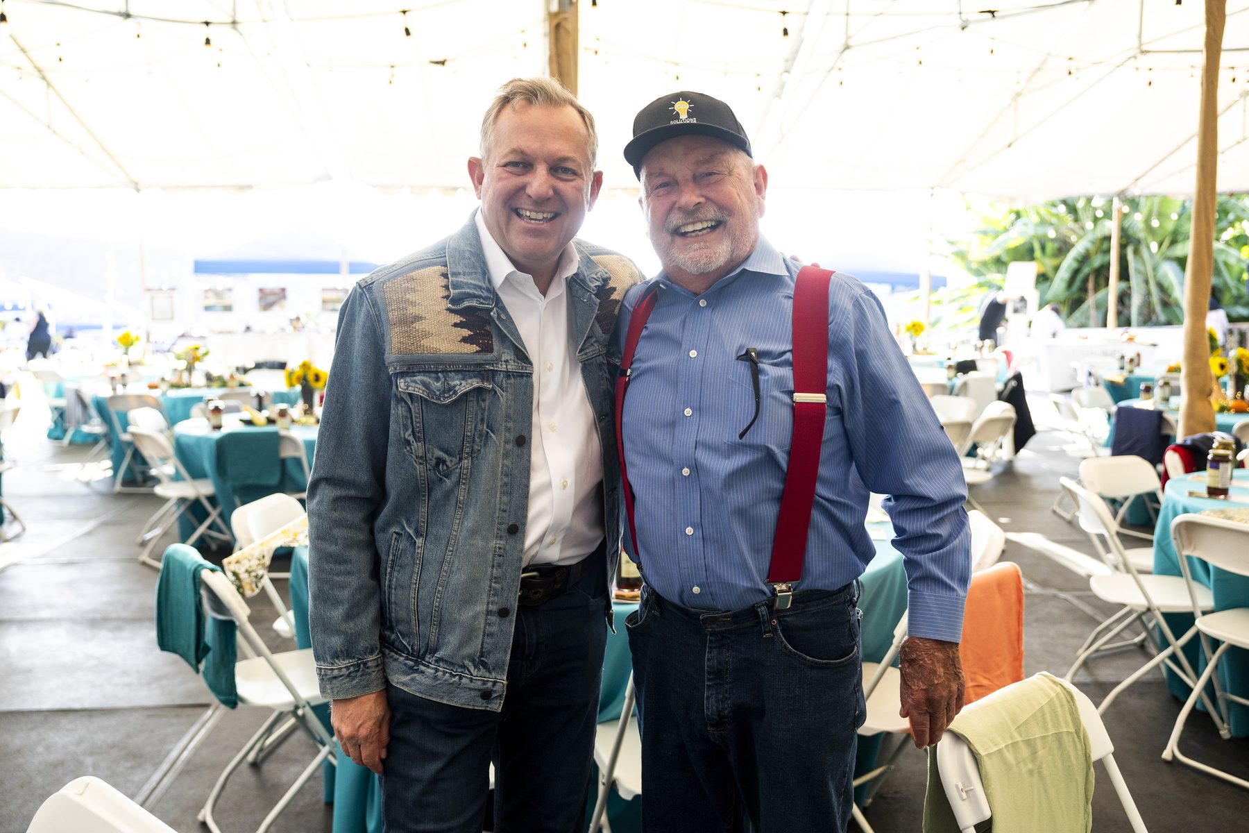 Two guests smiling together at the Harvest Moon dinner