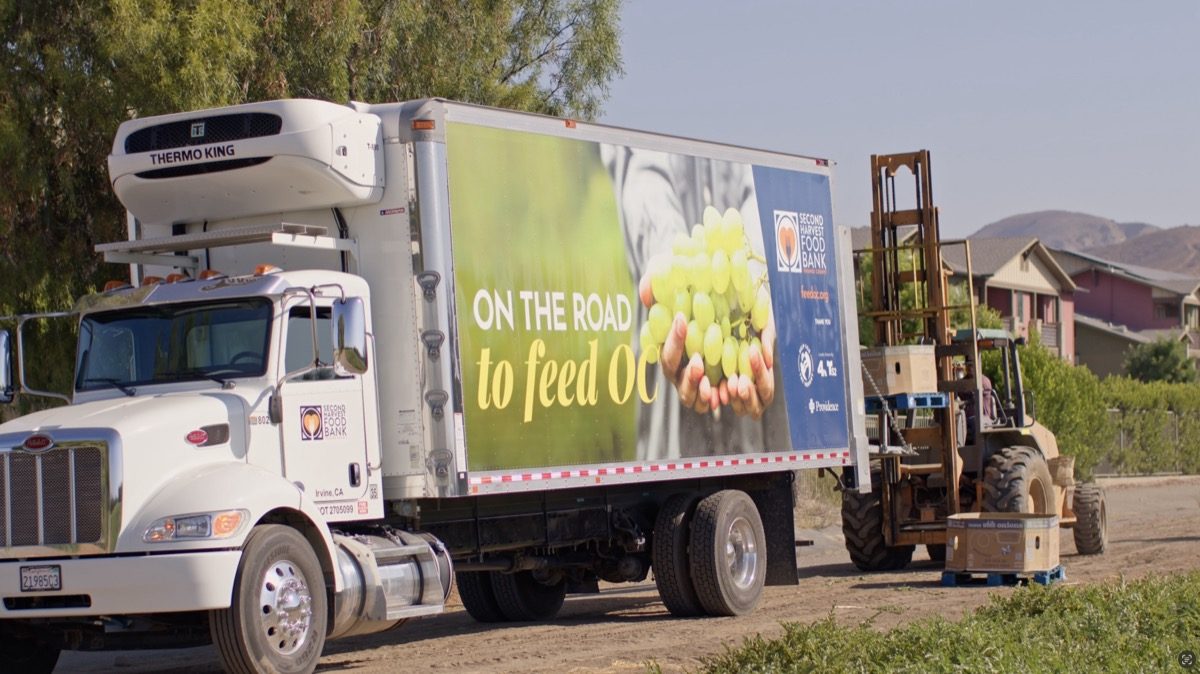 Second Harvest Food Bank truck being loaded with fresh produce at a partner farm